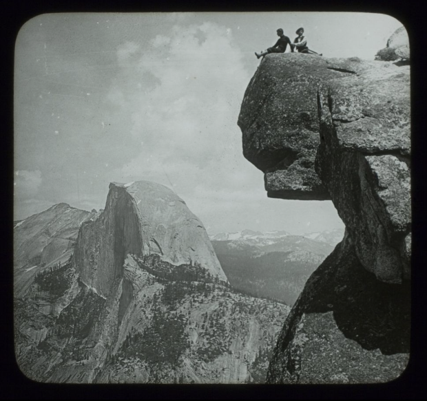 Lantern Slide of Two Figures on High on Top of a Rock, Looking towards Glacier Point in Yosemite National Park