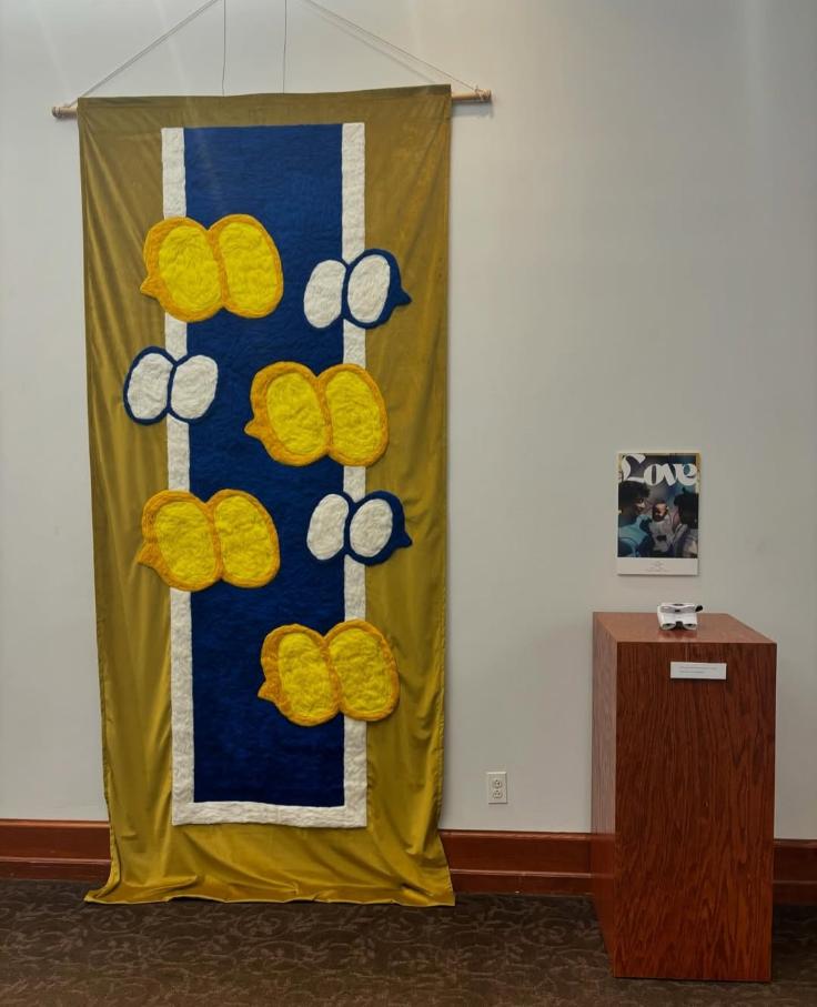 Yellow and blue tapestry with speech bubbles in the center.